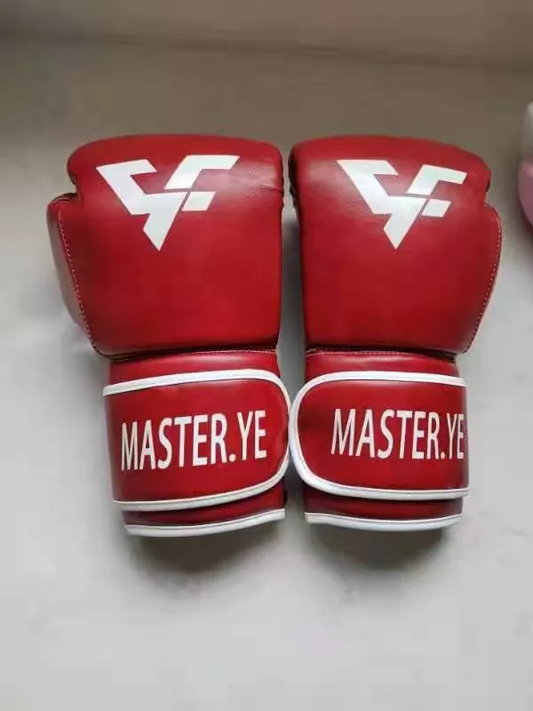 Boxing gloves ergonomic hand compartment and widened wrist strap design